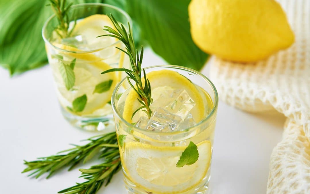 Drink with lemon and rosemary on table